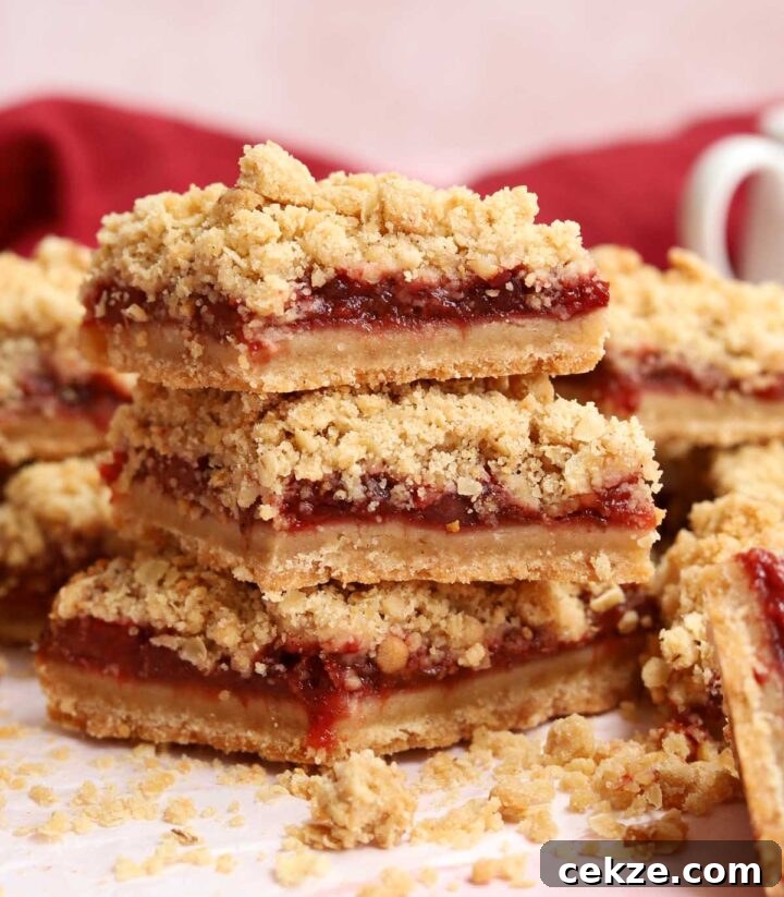 stack of sliced strawberry crisp bars on parchment paper