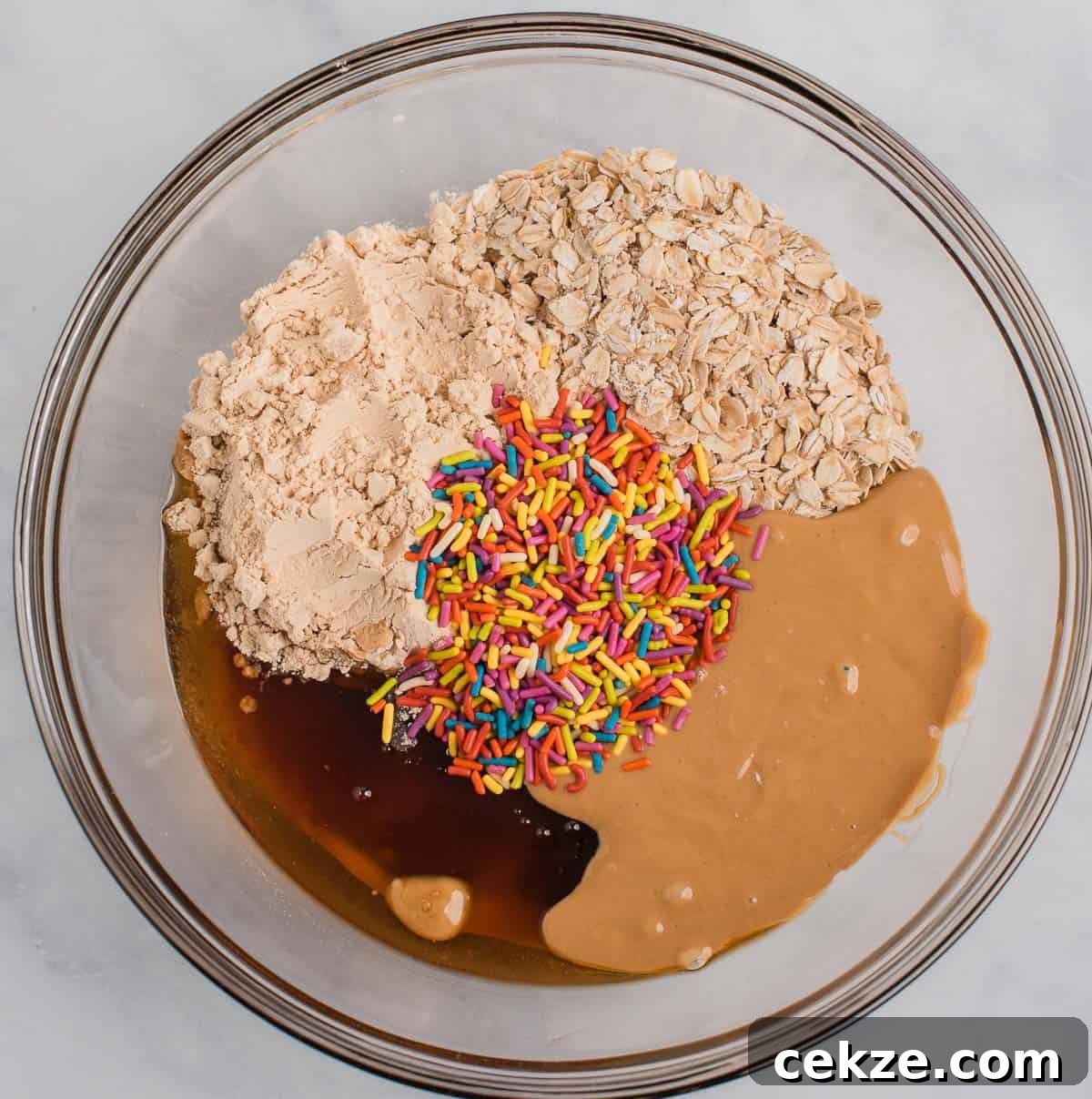 Birthday Cake Protein Balls Recipe for High-Protein Snacks 6 protein ball ingredients in a mixing bowl
