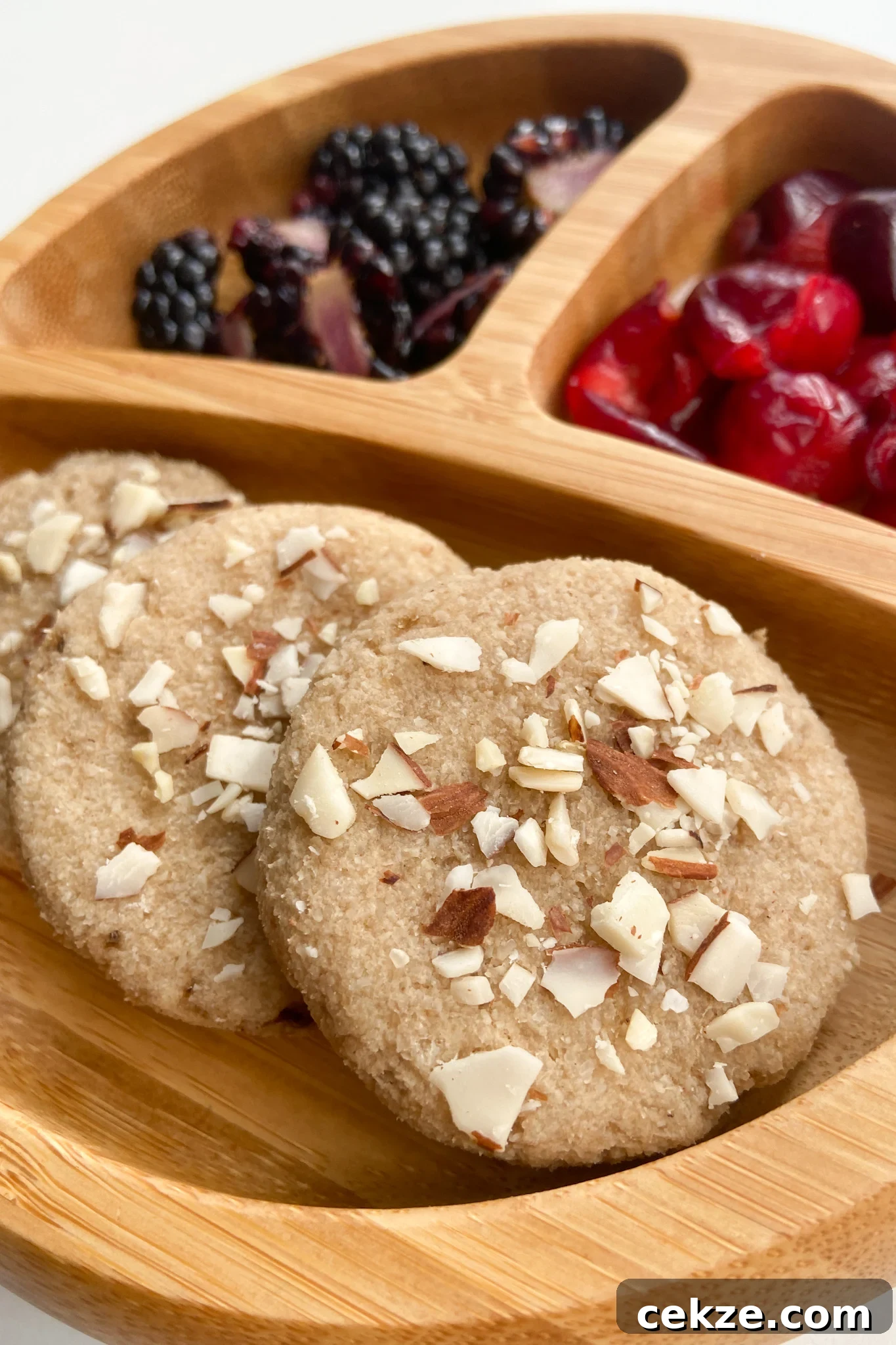 Almond cookies served with blackberries and cherries