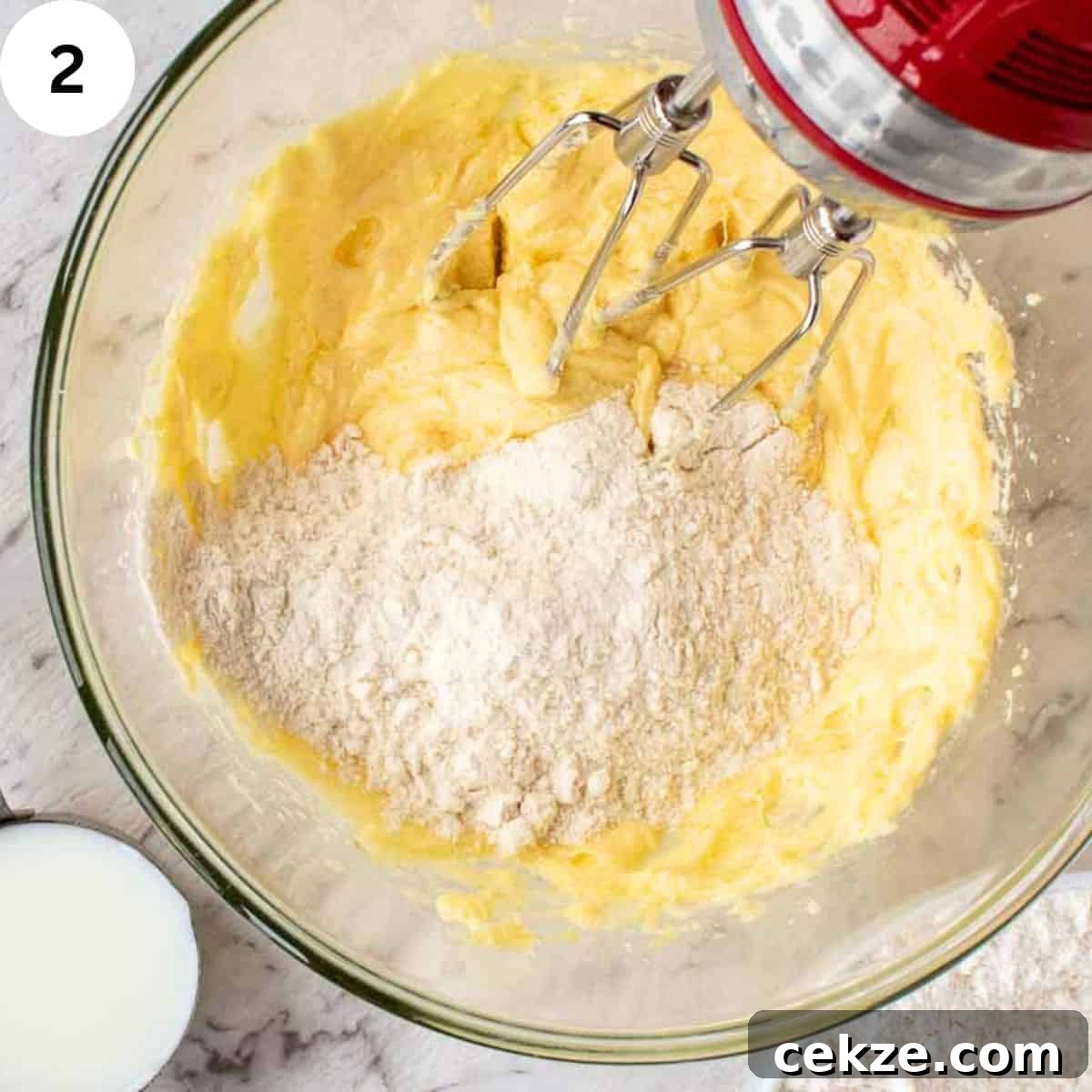 Classic German Plum Cake Recipe (Zwetschgenkuchen) 5 Mixing flour into a cream butter and sugar mixture.