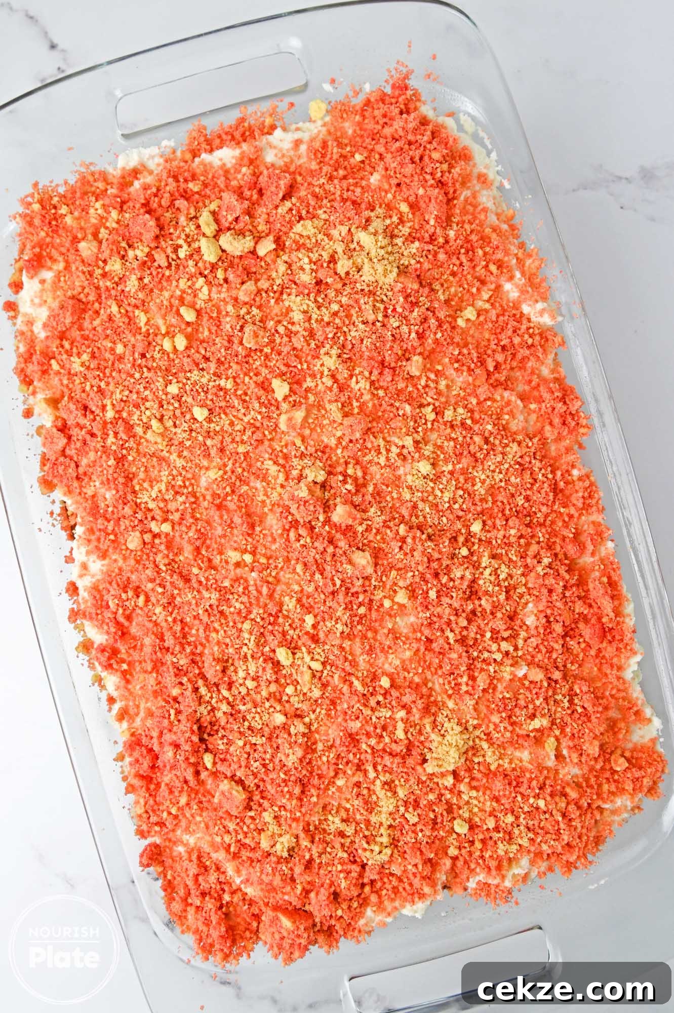 Overhead shot of strawberry crunch cake in a glass 9x13 inch pan