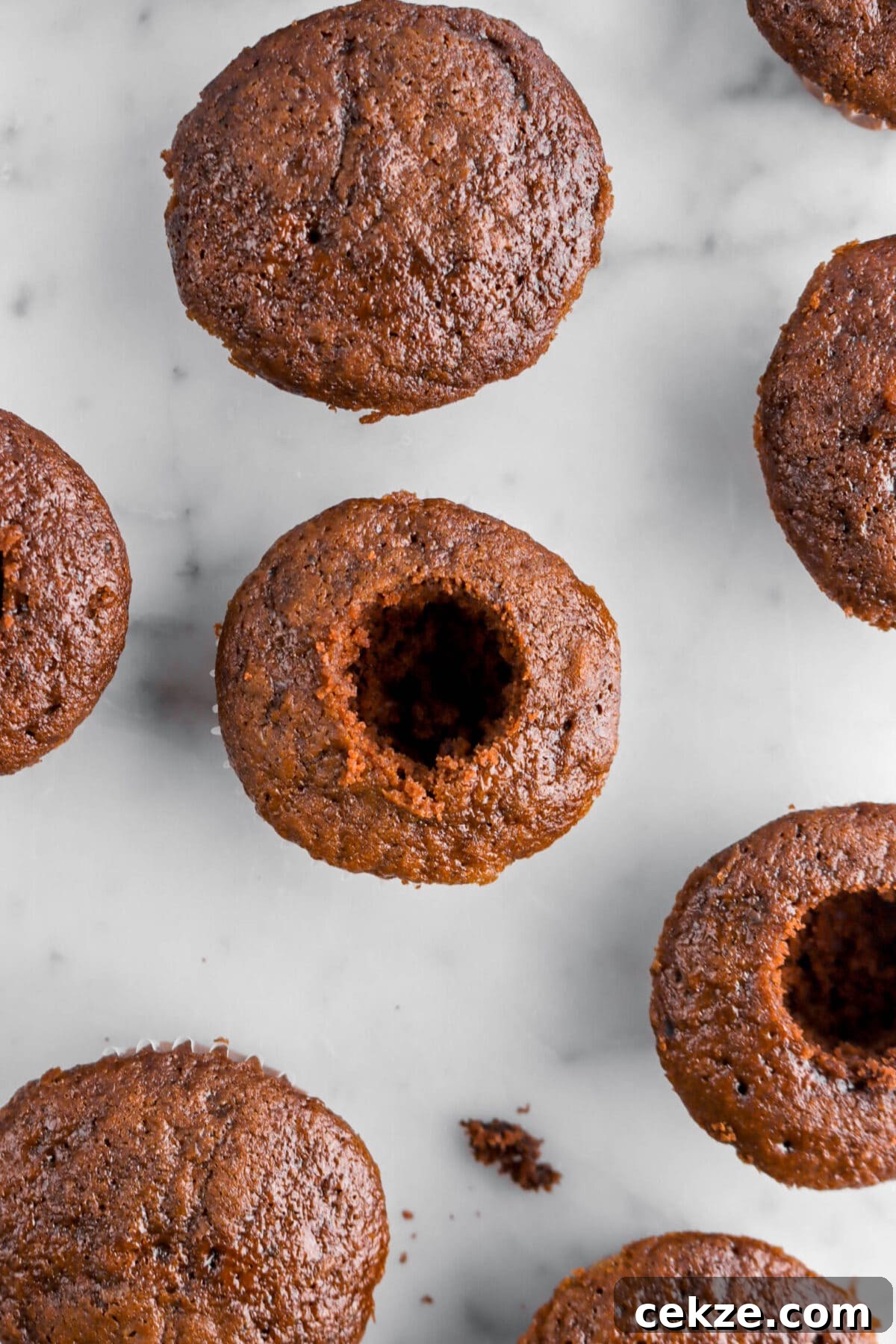 cored chocolate cupcakes on marble surface.