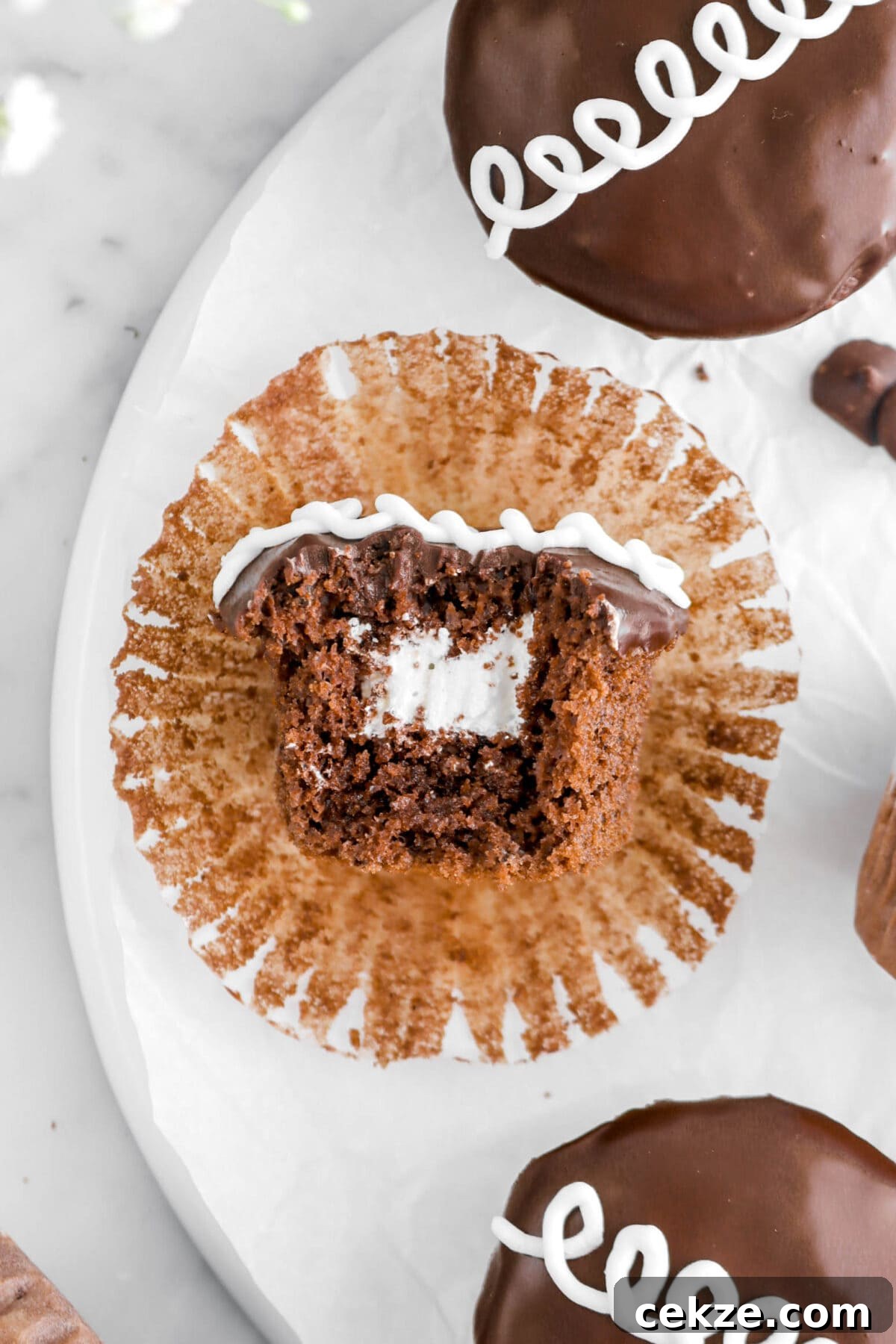 close up overhead shot of hostess cupcake with bite missing.
