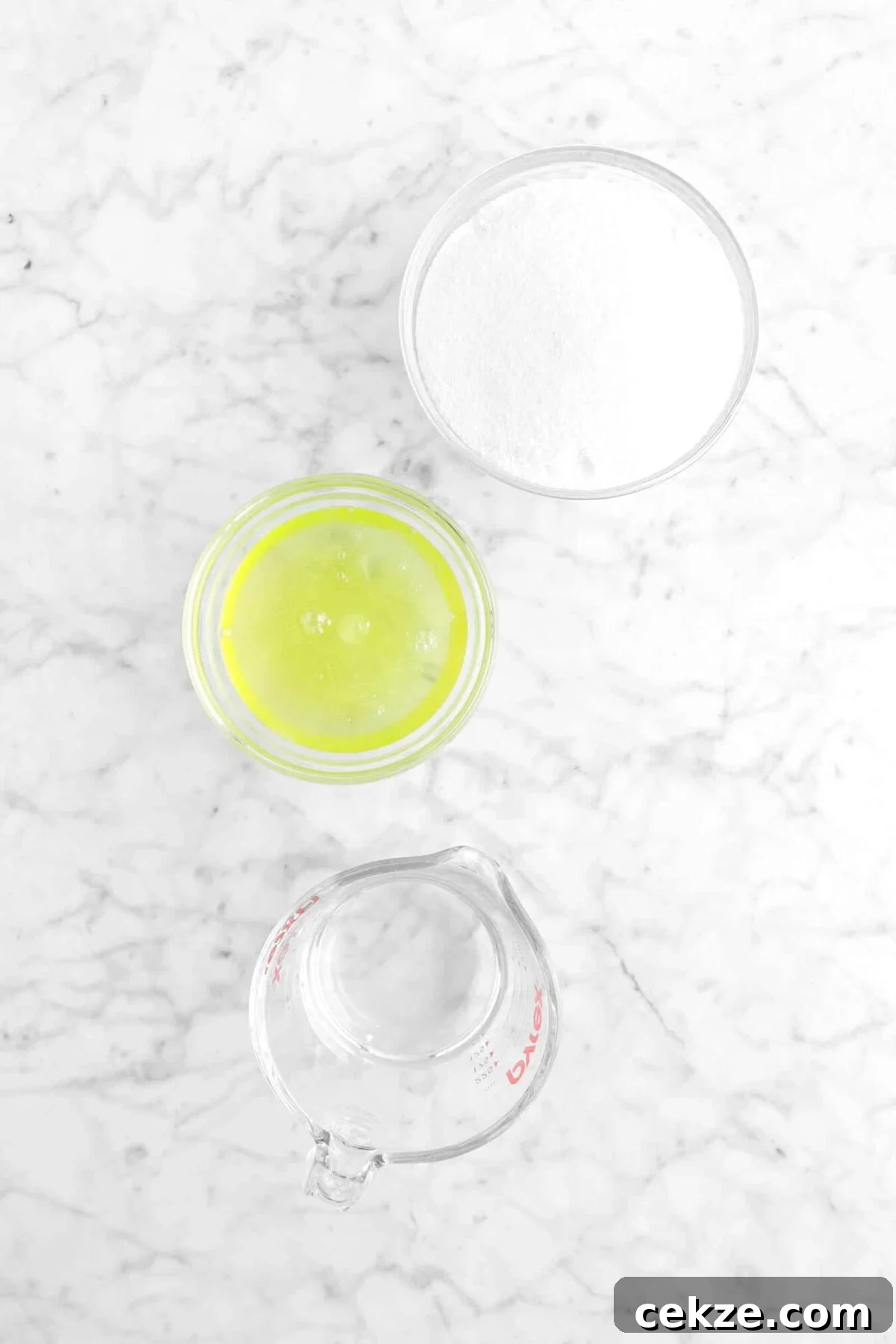 sugar, egg whites, and water on marble counter