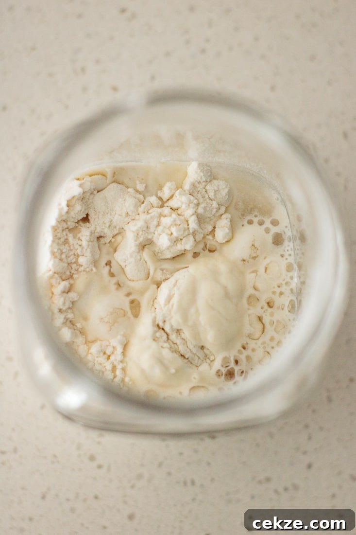 flour and water being mixed inside jar
