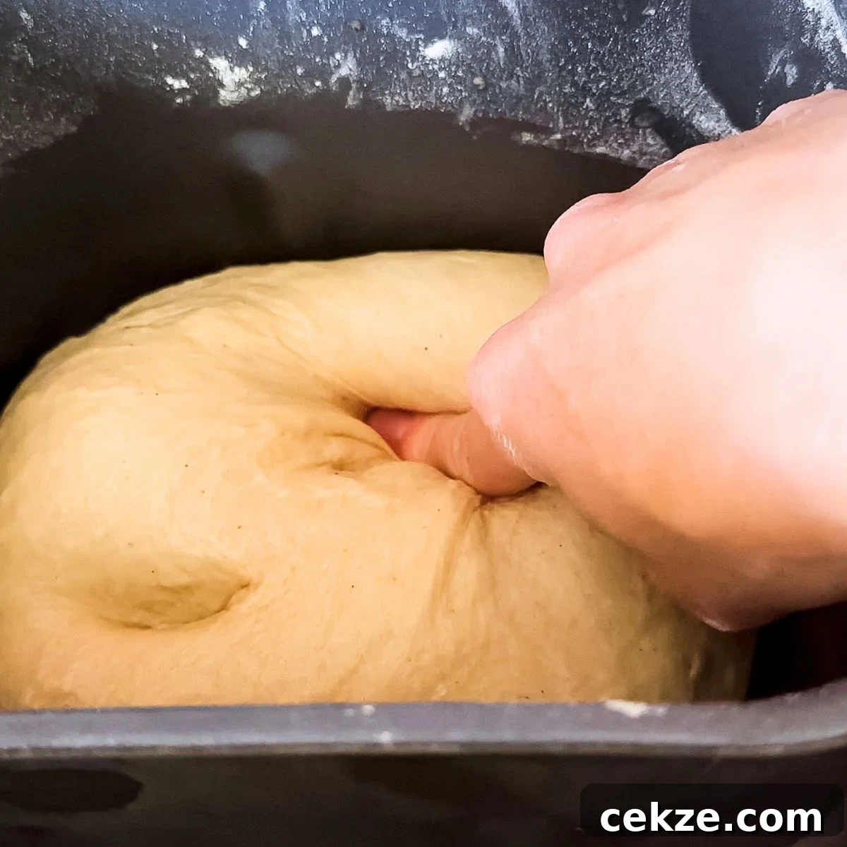 Poking the rising dough.
