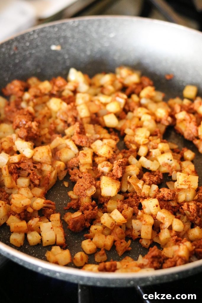 Baked Chorizo Egg Bites: Savory Breakfast Protein Cups 6 chorizo and potatoes, onions in skillet