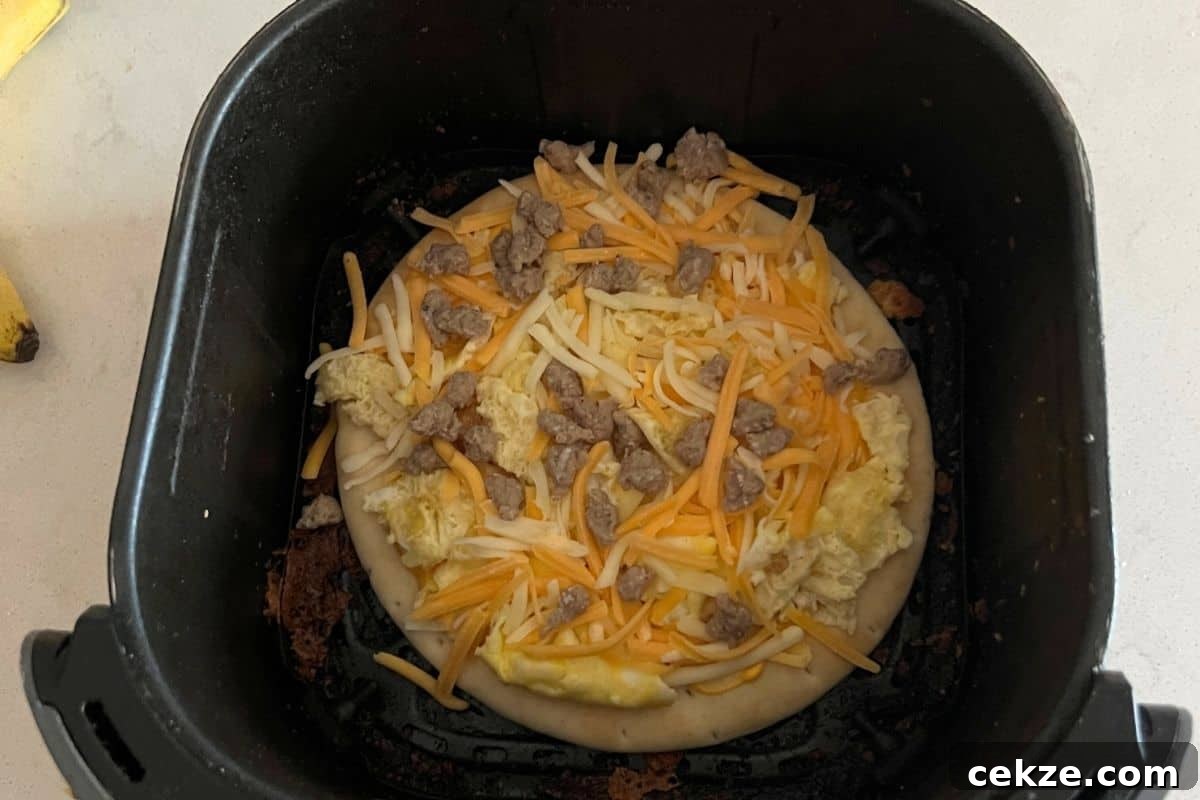 Crispy Air Fryer Breakfast Pizza Recipe for Quick Mornings 5 Breakfast pizza in air fryer basket.