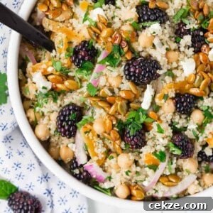 Quinoa and Chickpea Salad with Blackberries and Candied Pepitas 8 Colorful quinoa chickpea salad with blackberries, candied pepitas, onions, feta, and fresh herbs.