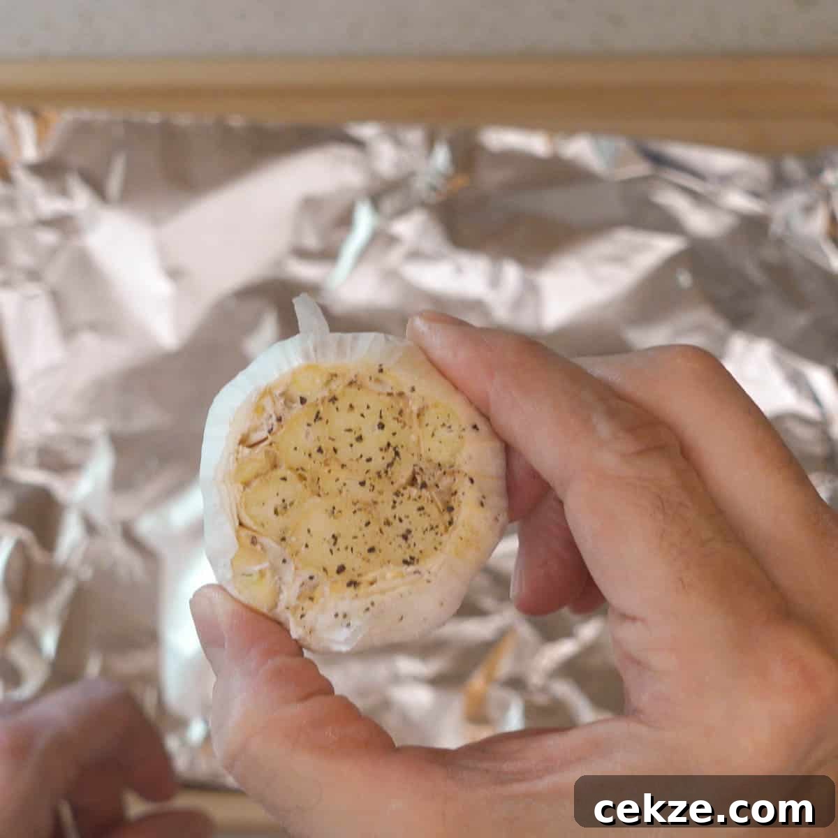 close up garlic bulb with olive oil salt and pepper