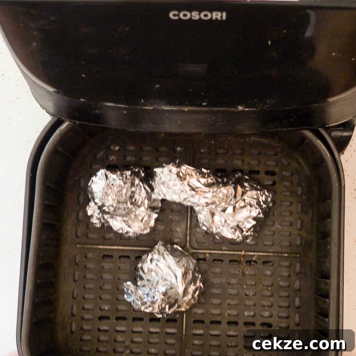 roasted garlic wrapped in aluminum foil ready to be roasted