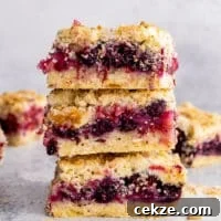 berry crumb bars stacked on top of each other