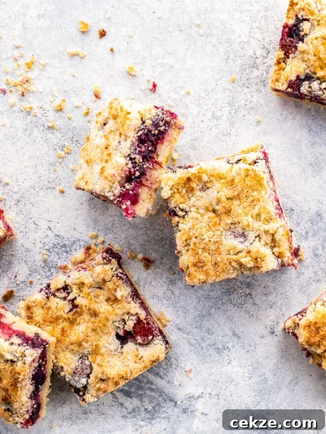 berry crumb bars scattered on a board