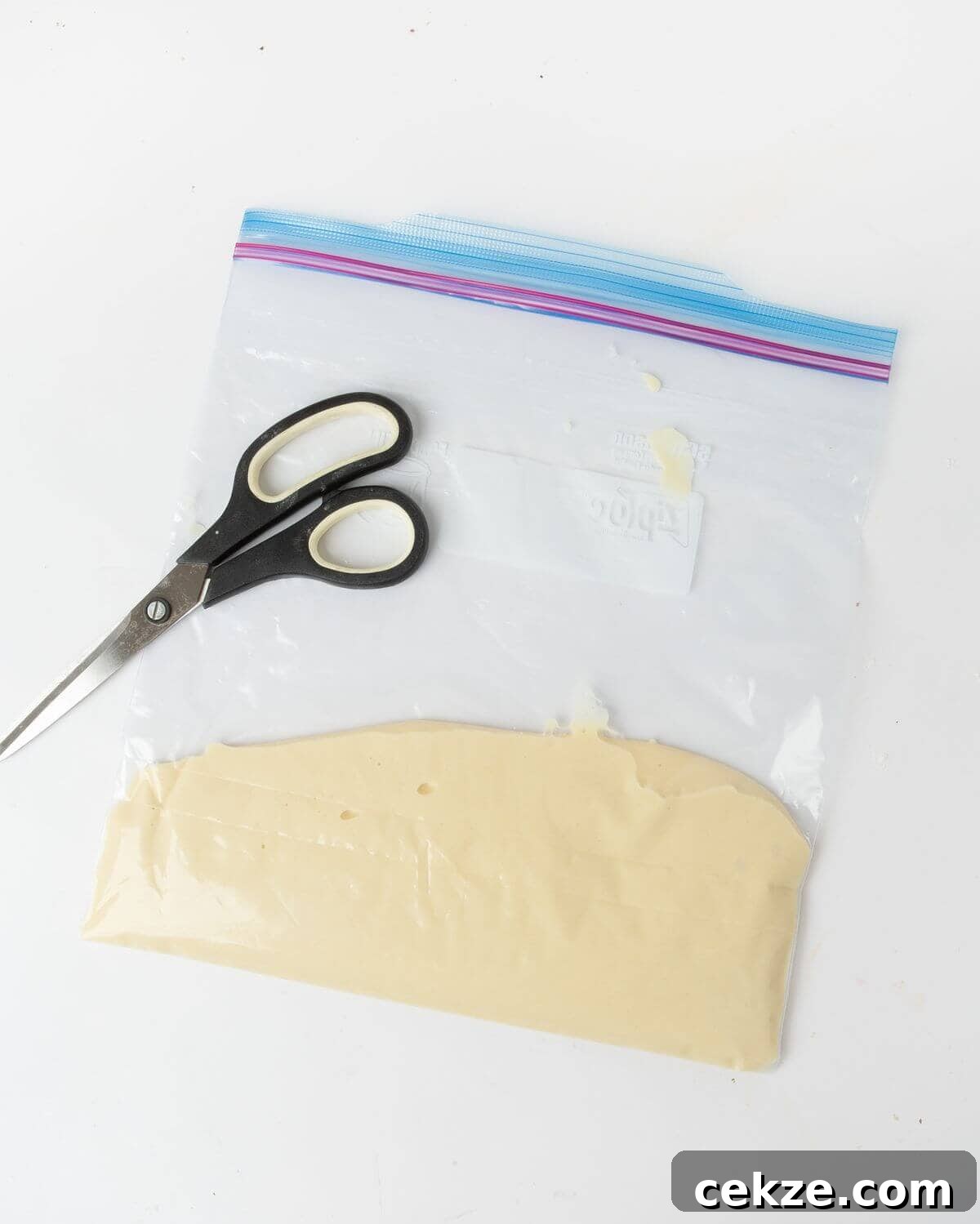 funnel cake batter in plastic bag with scissors