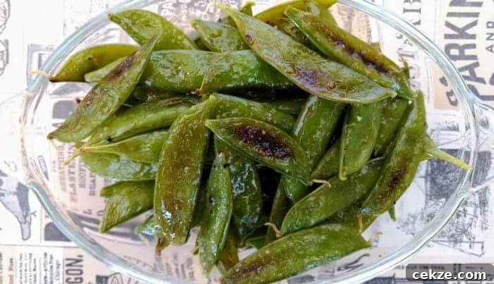 bowl of roasted sugar snap peas on table