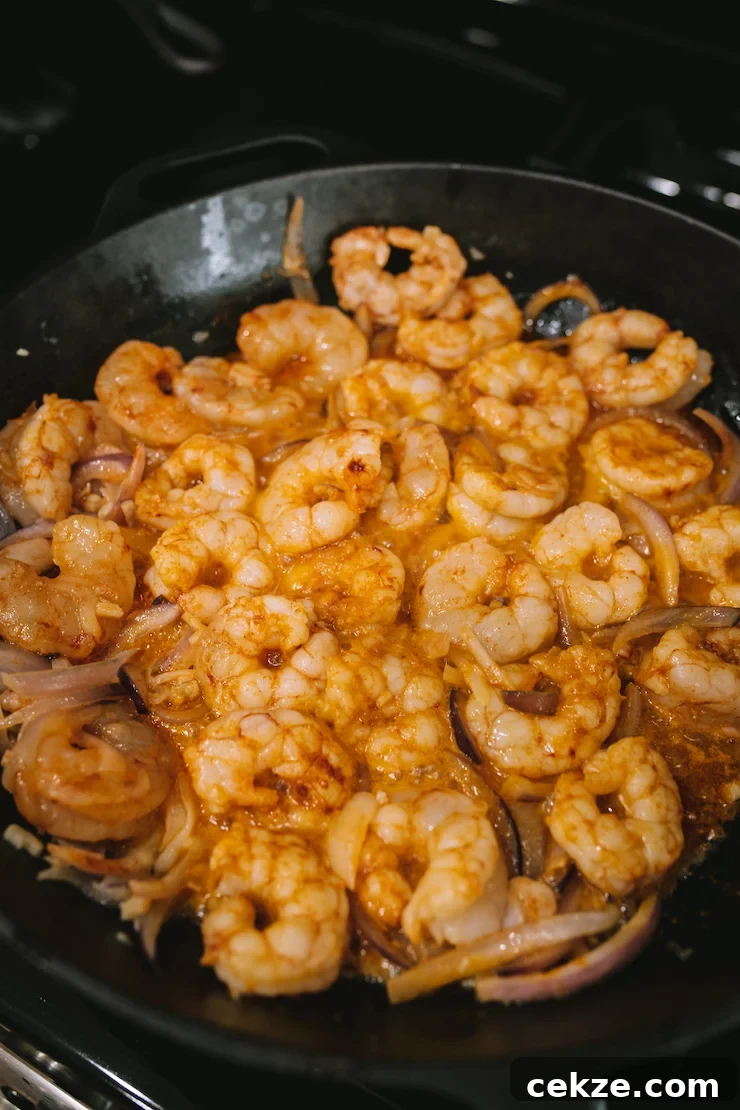 buttery Camarones al Mojo de Ajo cooking in the skillet.