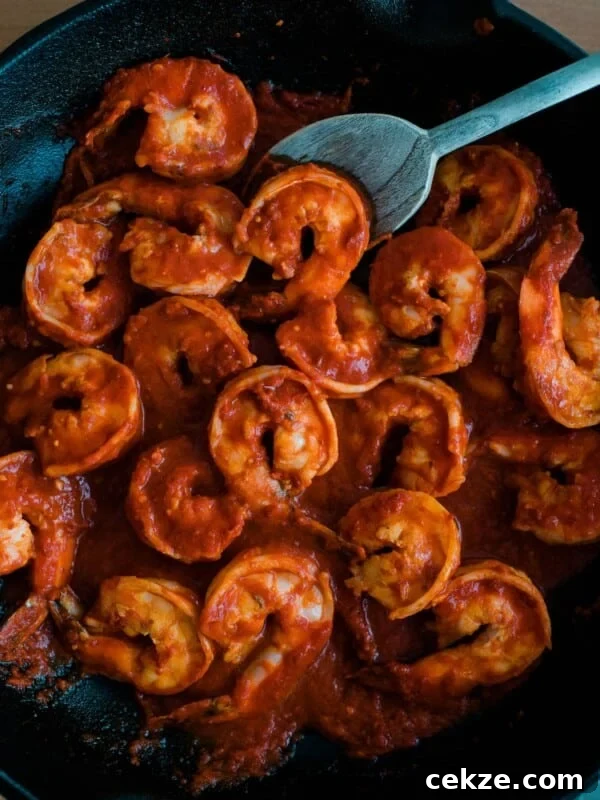 Camarones a la Diabla recipe simmering in a cast iron skillet
