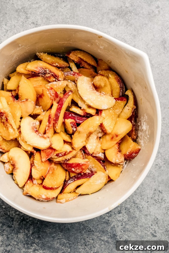 Perfect Peach Crisp Recipe for Summer Desserts 4 bowl of peach slices coated in sugar and flour
