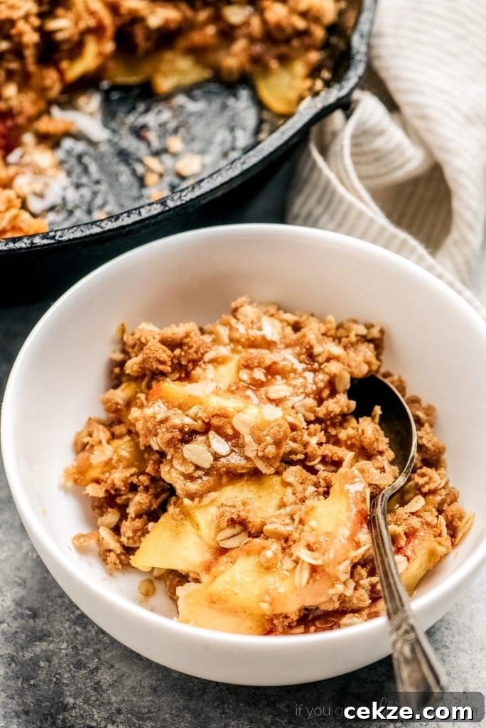 Perfect Peach Crisp Recipe for Summer Desserts 8 peach crisp serving in bowl with spoon