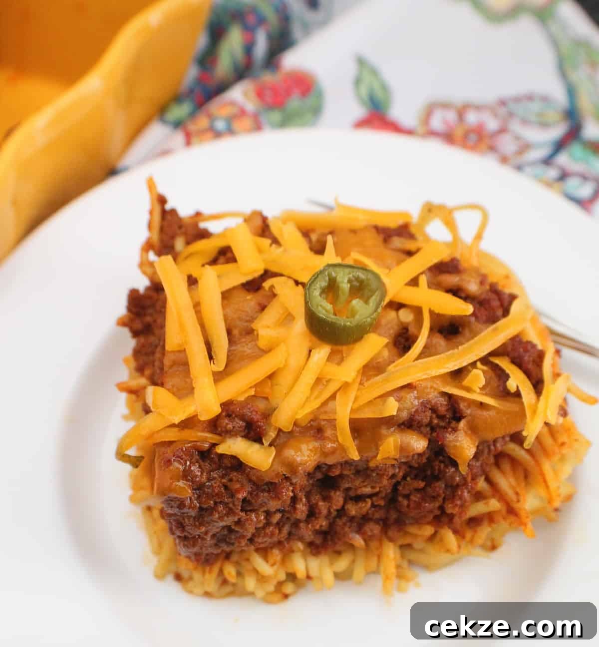 Chili spaghetti pie on white plate.