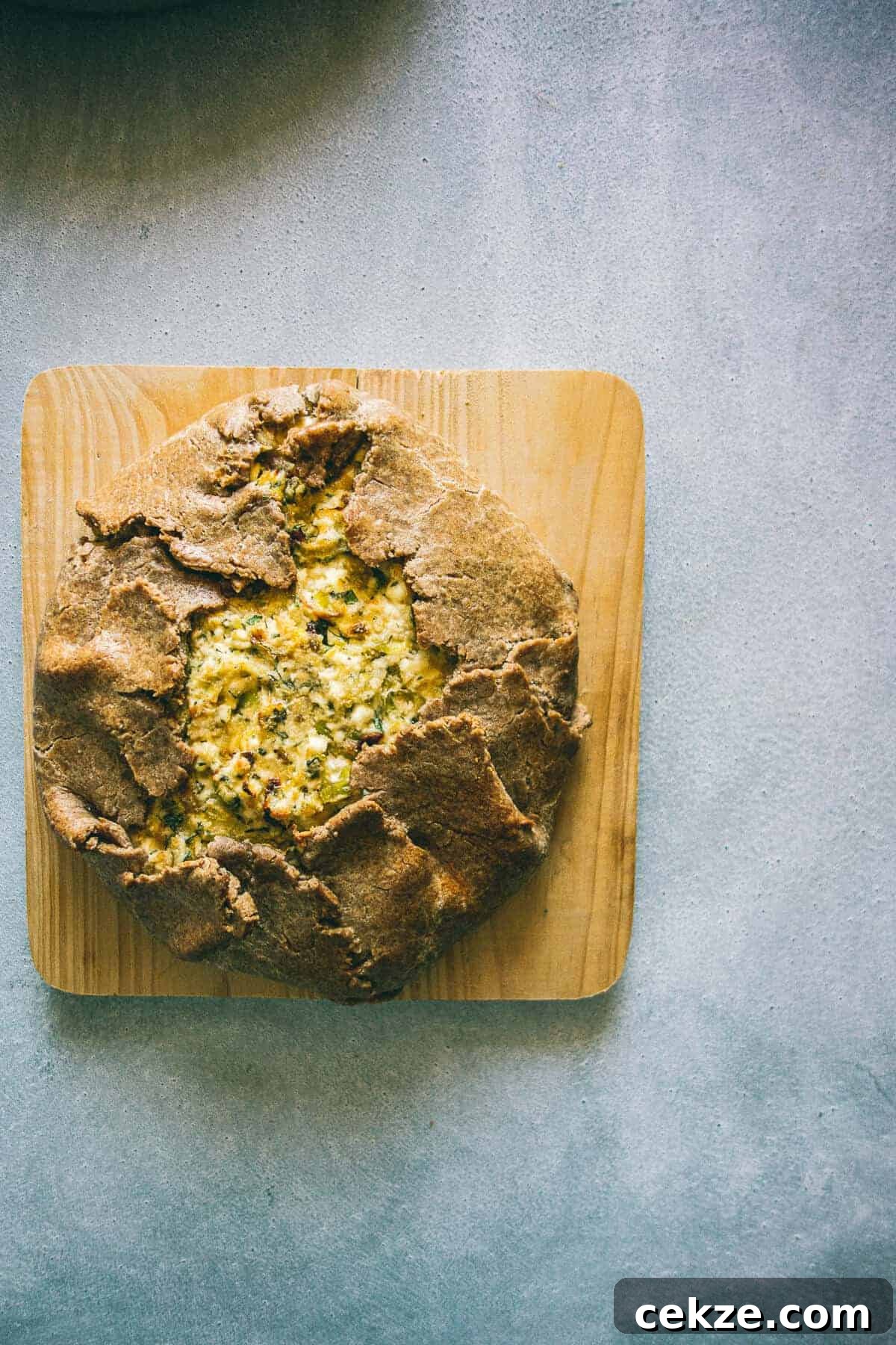Leek and Cheese Pie Recipe: Flaky Savory Tart with Gruyère 2 a rustic pie on a wooden board