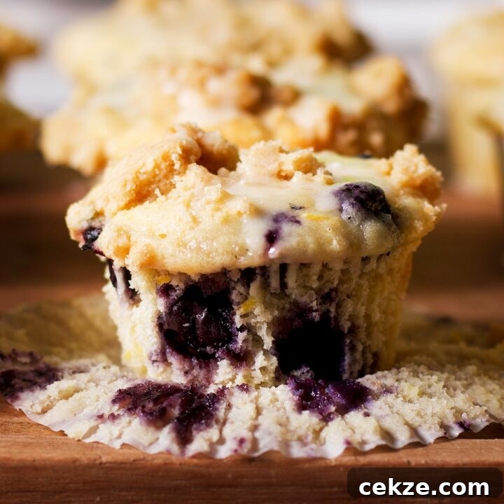 A blueberry lemon muffin on a wood board.