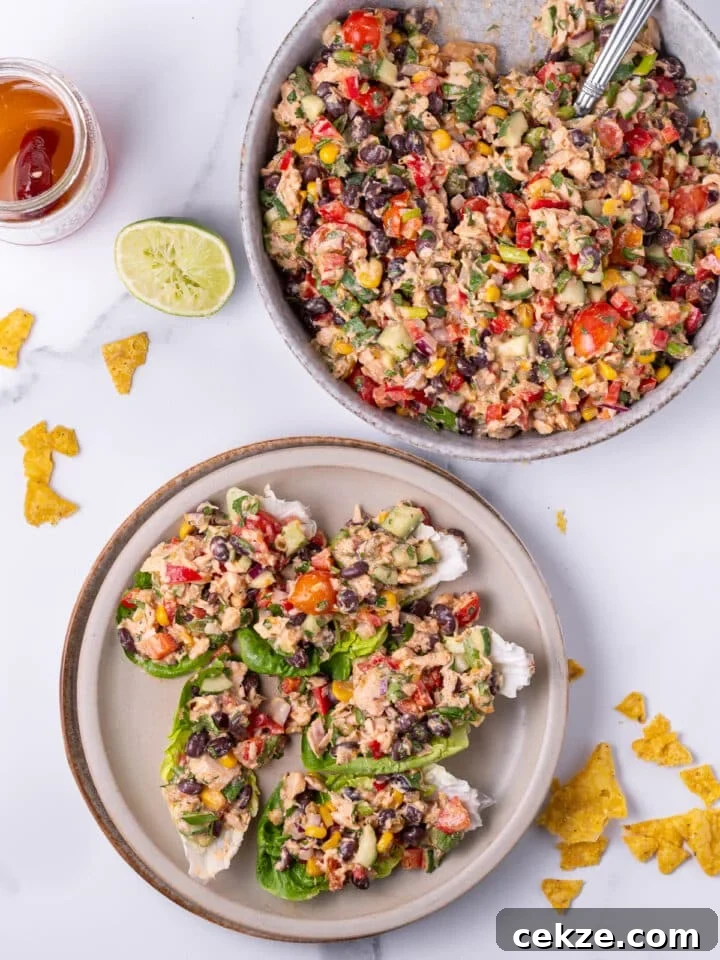 large serving bowl of Mexican-inspired tuna salad and serving plate with five lettuce cups filled with salad