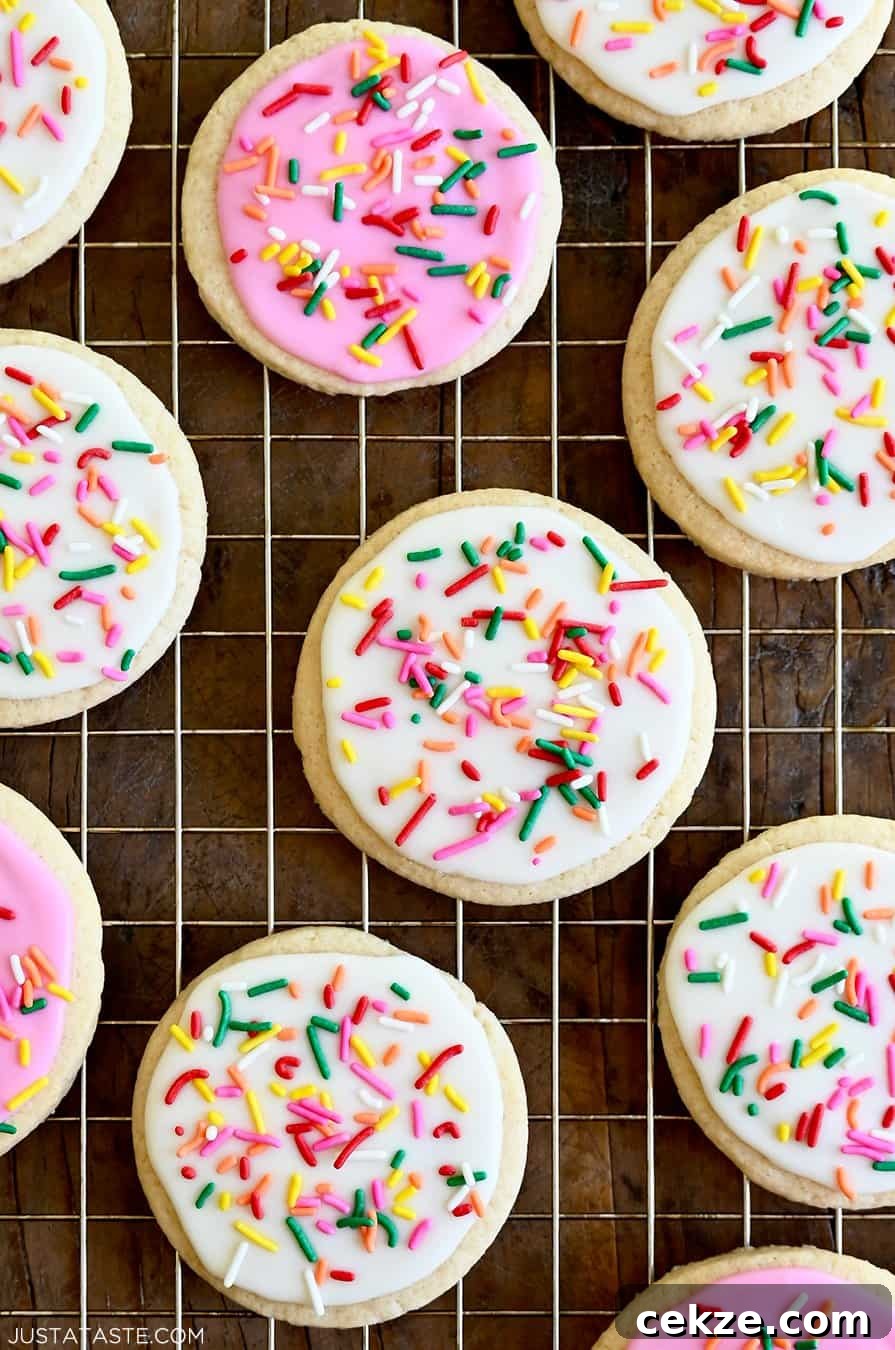 Perfect Sugar Cookie Icing Recipe for Smooth, Glossy Frosting 8 A closeup view of homemade sugar cookies frosted with vibrant pink and bright white icing