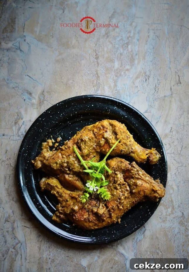 Authentic Afghani Chicken Roast Recipe from Mughlai Cuisine 2 Afgani chicken roast served over a plate.