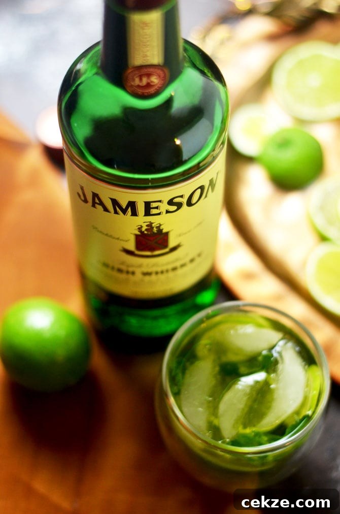 Melon Whiskey Ginger. This simple cocktail features midori melon liqueur, Jameson whiskey, ginger ale, lime wheels, and fresh mint. It's perfect for St. Patrick's Day, and delicious enough to become a go-to summer drink as well! | hostthetoast.com