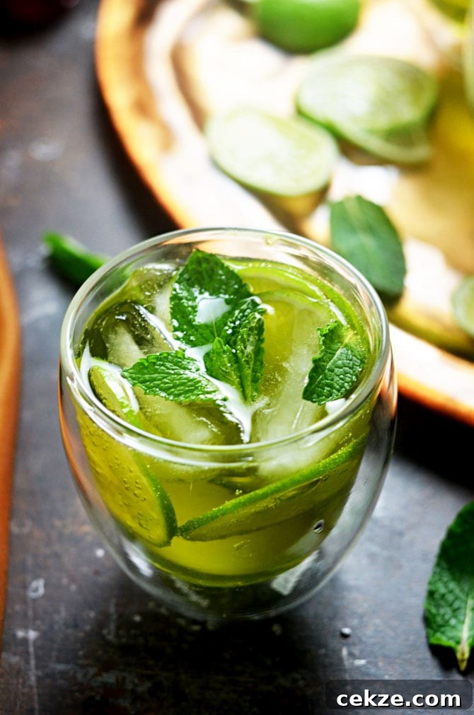 Melon Whiskey Ginger. This simple cocktail features midori melon liqueur, Jameson whiskey, ginger ale, lime wheels, and fresh mint. It's perfect for St. Patrick's Day, and delicious enough to become a go-to summer drink as well! | hostthetoast.com