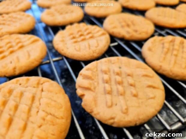 Golden brown peanut butter cookies cooling on a wire rack.