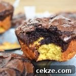 Deep Dish Brookies with a bite out of one on top of a muffin pan.