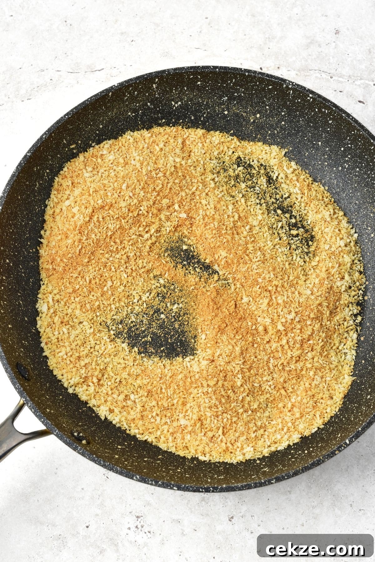 How to Make Turkey Nuggets Toasting panko breadcrumbs in skillet.