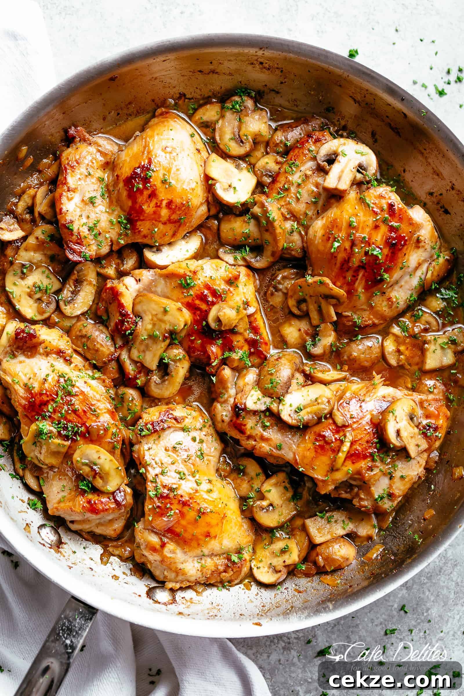 Golden seared chicken thighs with buttery garlic mushroom sauce with a sprinkle of herbs Served over rice, pasta, mashed potatoes OR lower carb options like mashed cauliflower or zucchini noodles!