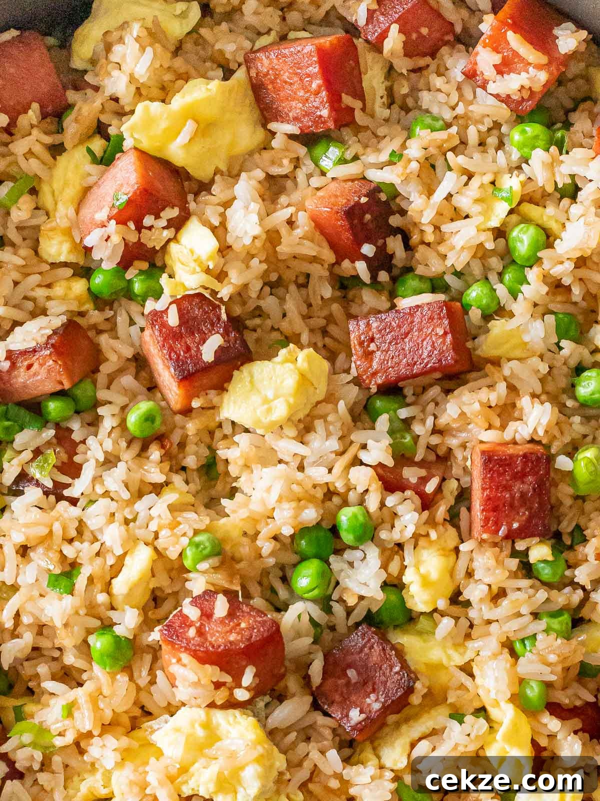 overhead of spam fried rice with eggs and green peas