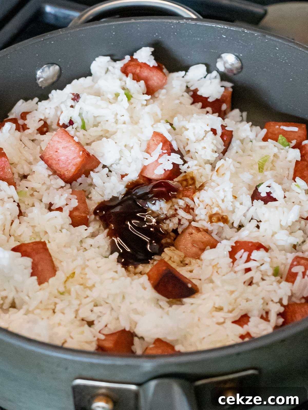 spam and rice frying in a nonstick pan
