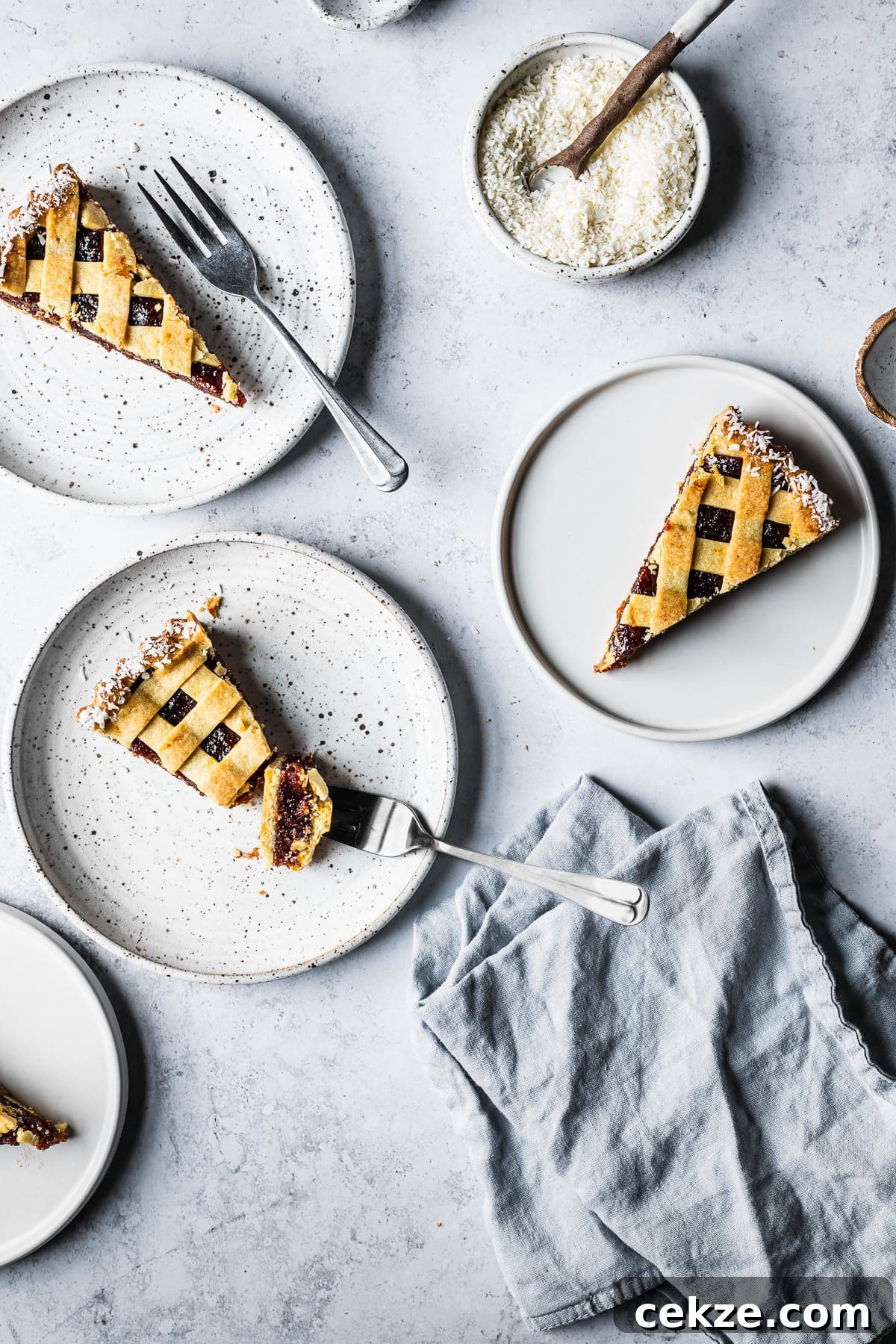 Three slices of lattice topped pasta frola (quince tart) on plates 