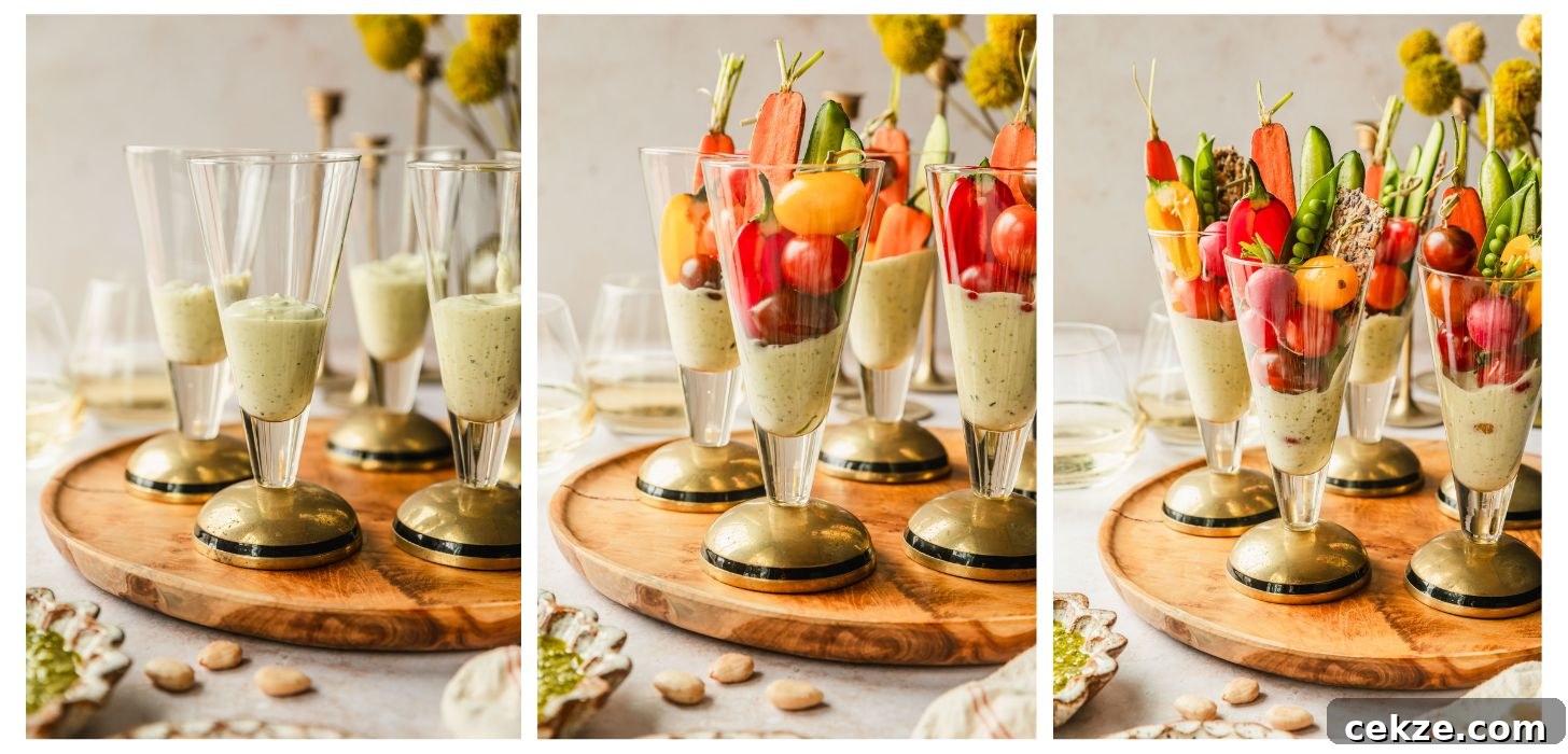 Three steps to making crudités cups. In photo 1, glasses of pesto dip is on a wood board next to yellow flowers and glasses of white wine on a tan counter. In photo 2, the cups have carrots, cucumbers, cherry tomatoes, and peppers. In photo 3, the cups have radishes, crackers, and snap peas.