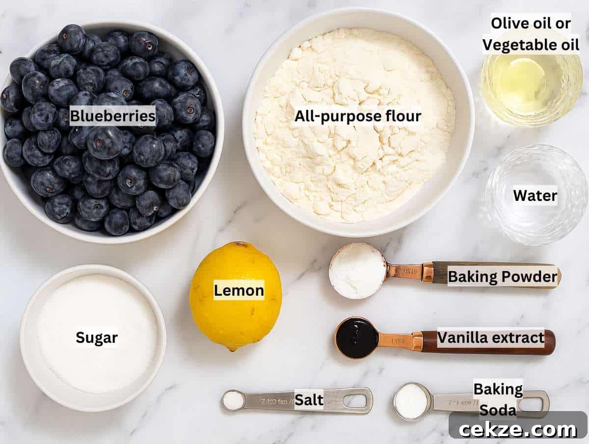 Ingredients for blueberry tart on a marble table.