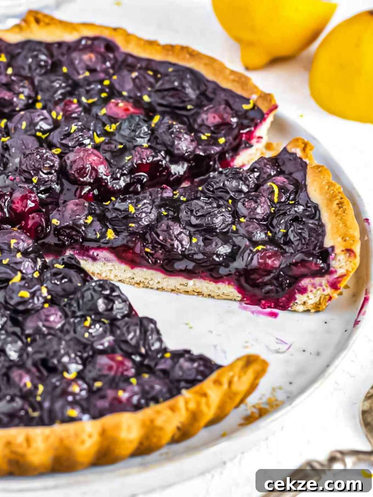 Blueberry tart sliced with jammy blueberry filling.
