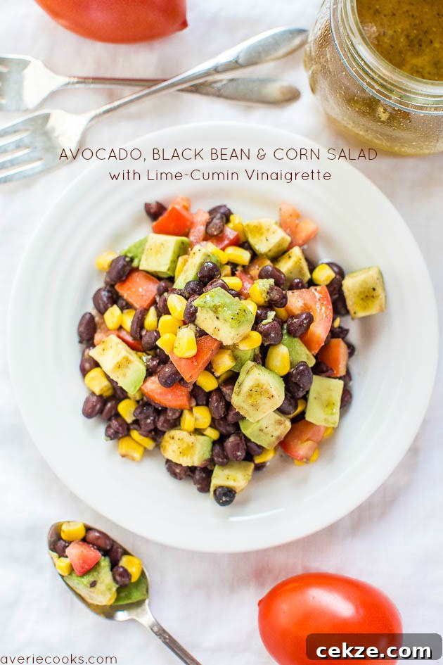 Avocado, Black Bean and Corn Salad with Lime-Cumin Vinaigrette in a white bowl.