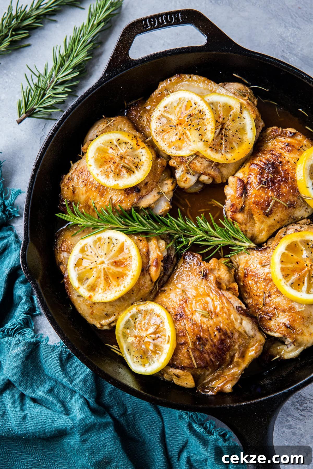 Top Chicken Thigh Recipes for Flavorful Weeknight Dinners 24 Lemon rosemary braised chicken thighs in a cast iron skillet