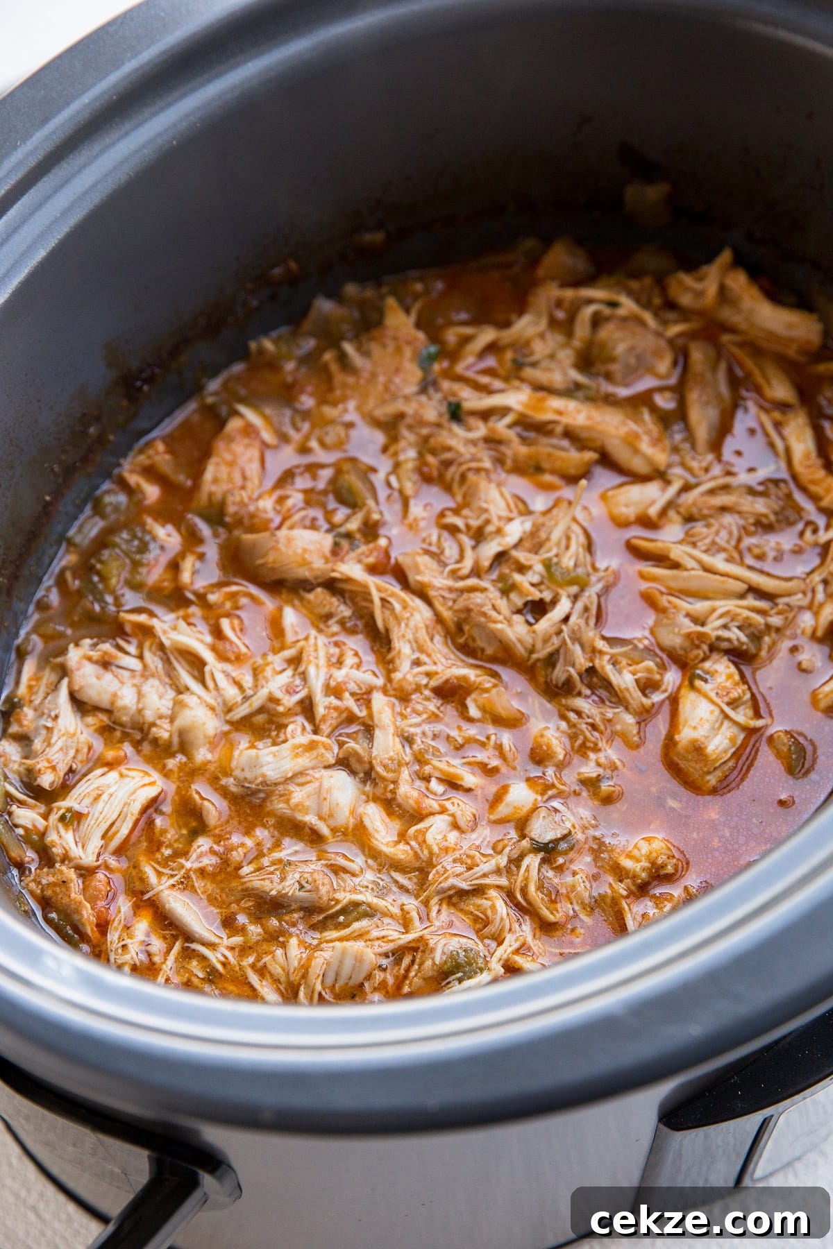 Top Chicken Thigh Recipes for Flavorful Weeknight Dinners 10 Slow cooker with shredded Mexican chicken inside