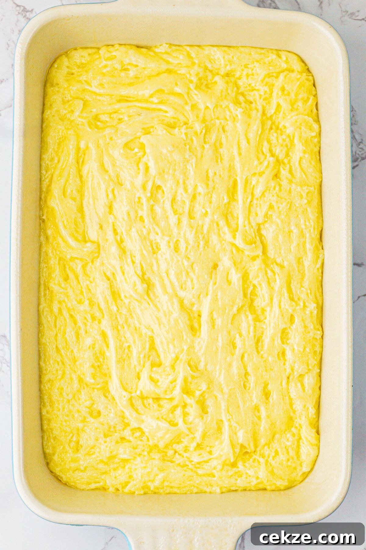 2-Ingredient Lemon Bars Recipe — Quick Tangy Dessert 5 9x13 baking dish with batter mixed and spread into dish.