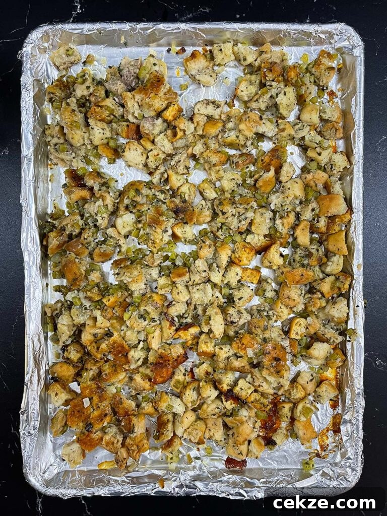 Stuffing spread out on a baking sheet to crisp in the oven.