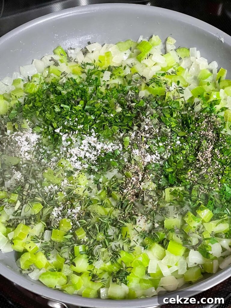 Sweated onion and celery in a skillet with fresh parsley, sage, and thyme just added.