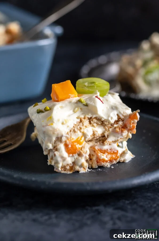No-Bake Fruit Custard Icebox Cake Recipe: Quick Chilled Dessert 2 piece of icebox cake showing layers of cream, fresh fruits and cookies