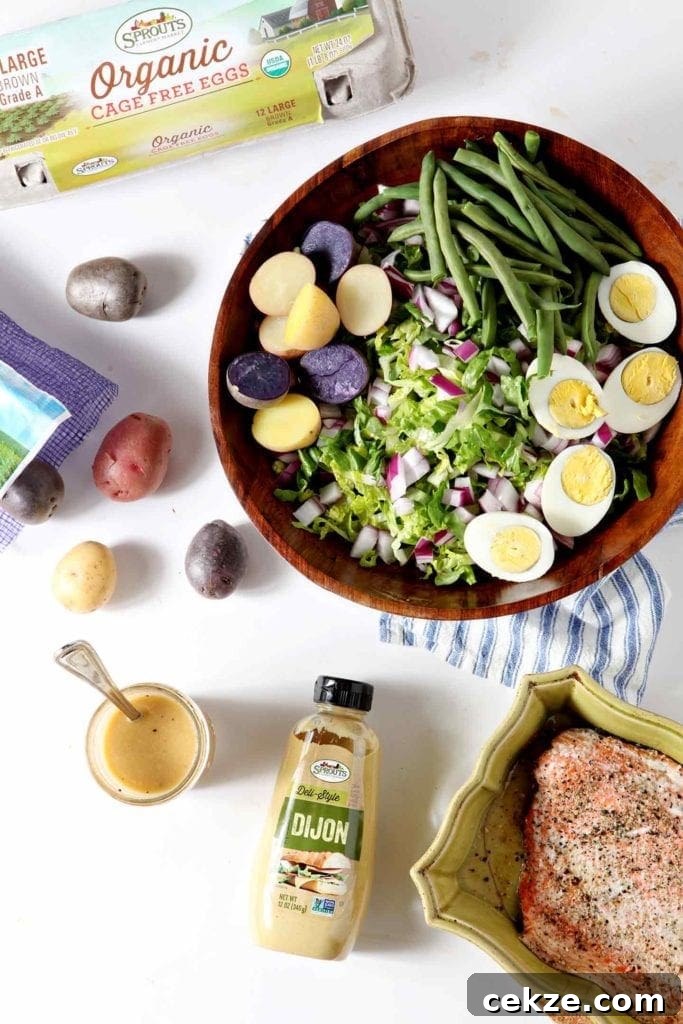 Grilled Salmon Niçoise Salad Recipe with Lemon Vinaigrette 3 nicoise salad in a large mixing bowl