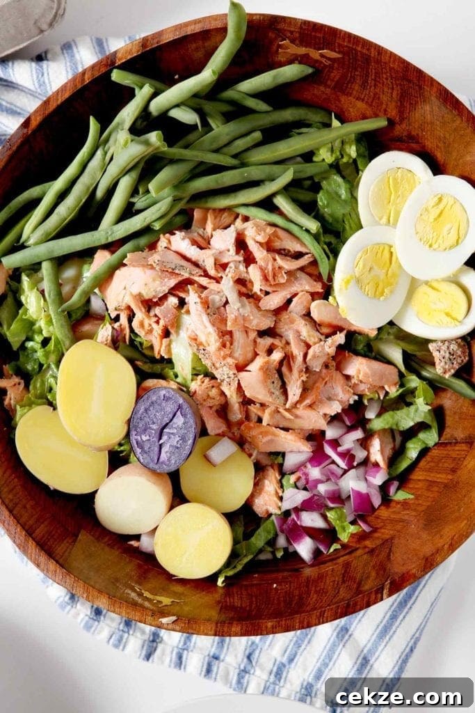 Grilled Salmon Niçoise Salad Recipe with Lemon Vinaigrette 5 wggs, green beans, tuna, red onion in a large bowl